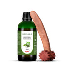 Bottle of Green Milk Aloe Vera Massage Oil with a wooden massage tool on a white background
