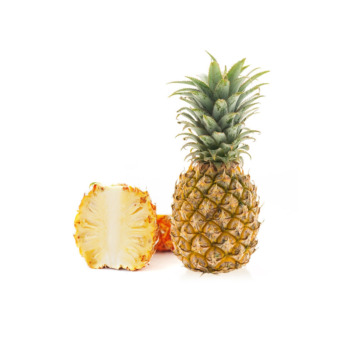 Whole pineapple and a sliced pineapple on a white background