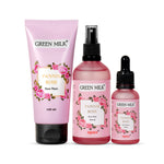 Three skincare products from GREEN MILK brand including a face wash tube, a spray bottle, and a dropper bottle, all in pink packaging with floral designs.