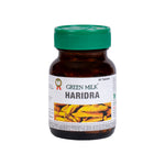 Bottle of Green Milk Haridra tablets with a green cap on a white background