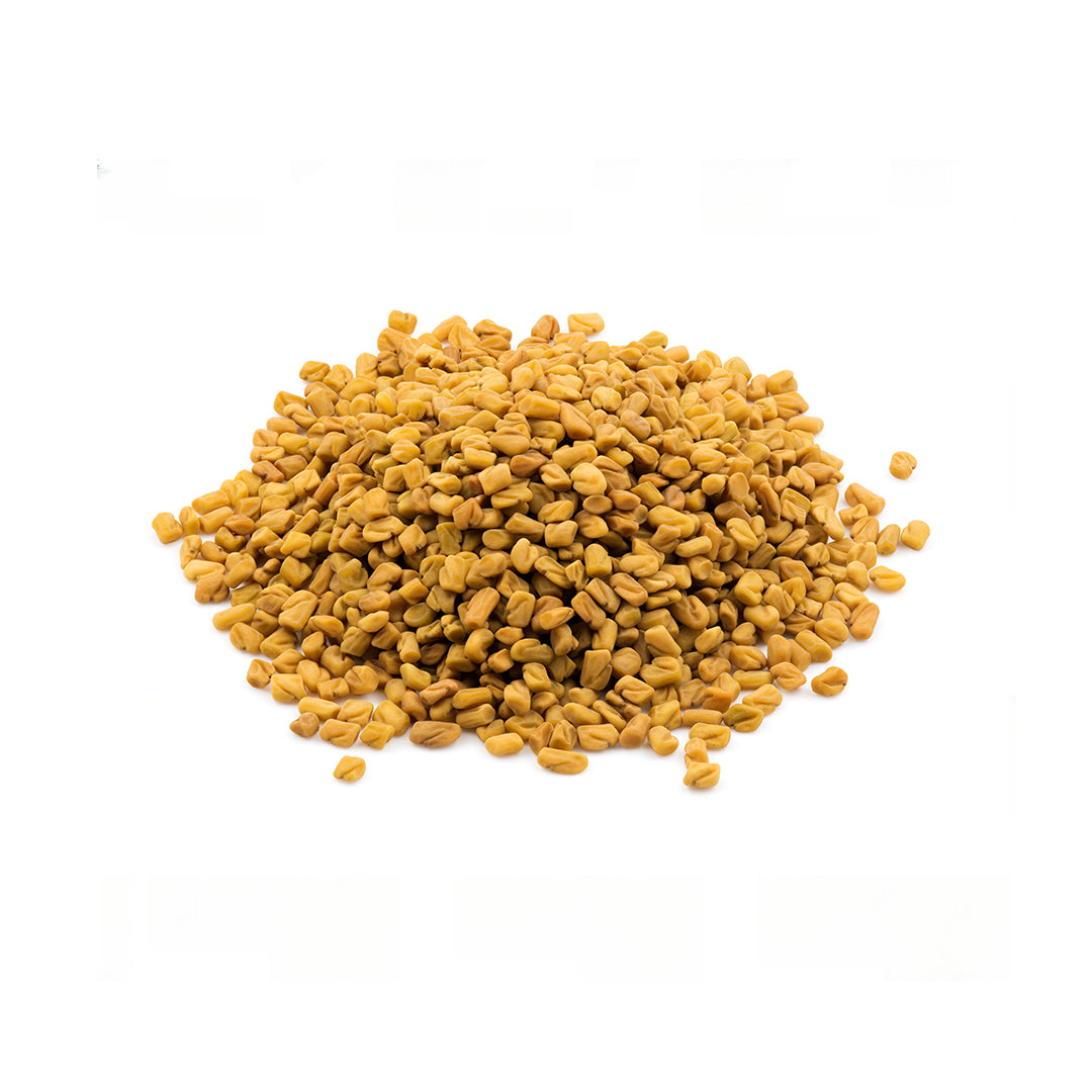 Pile of yellow fenugreek seeds on a white background