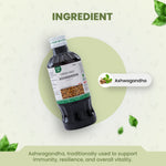 Bottle of Ashwagandha supplement with green leaves on a light background