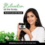 Woman holding a jar of Brahmi Lab Hair Mask with text about scalp care and ayurvedic hair care.