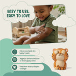 Child applying cream to their arm with a tiger-shaped container and text about its use.