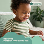 Child wearing a green and white striped shirt with a product label indicating dermatological and pediatric testing.