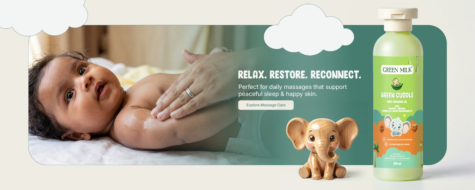 Baby lying on a blanket with a bottle of green baby product and a toy elephant in the background.