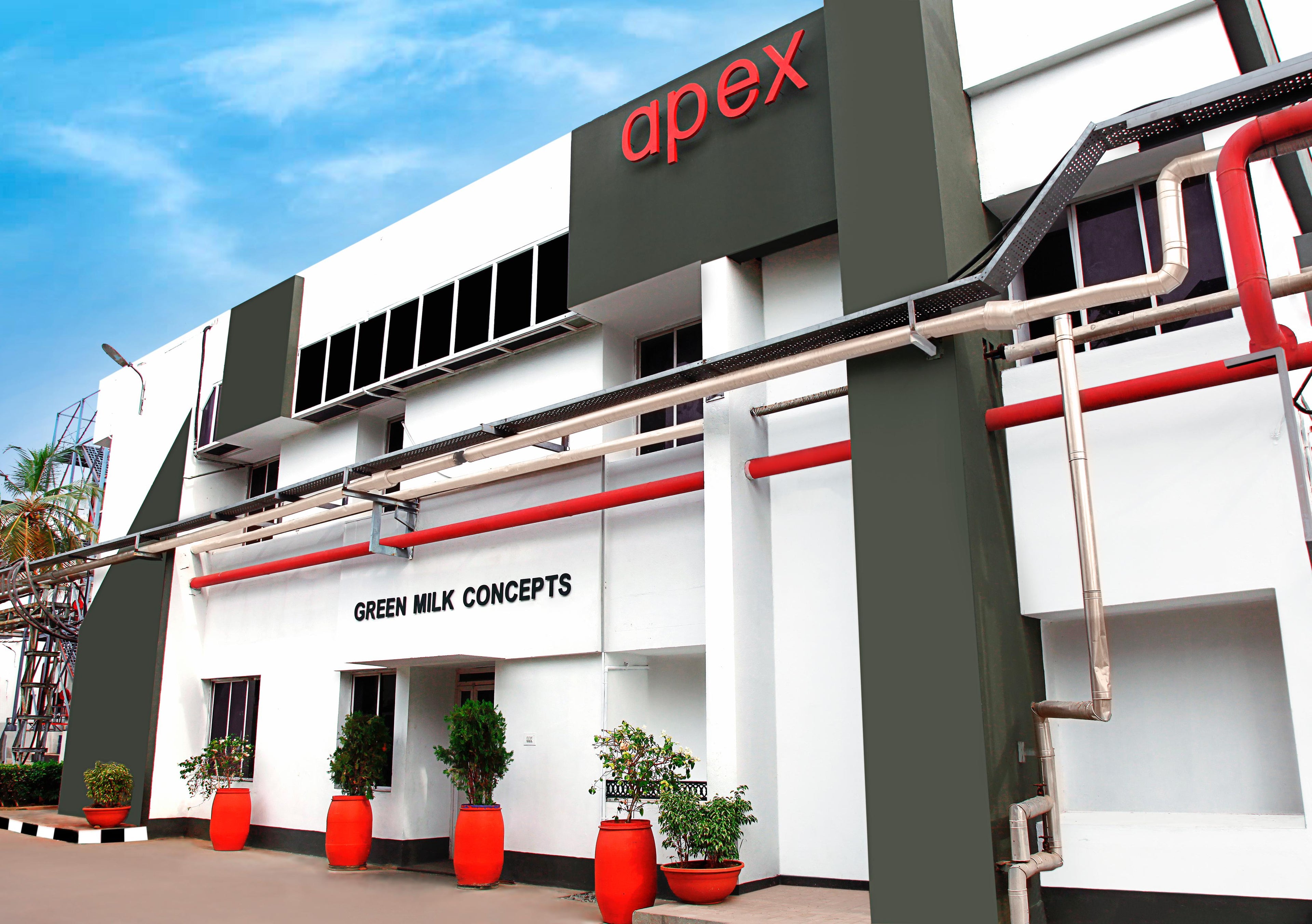 Building with 'apex' and 'Green Milk Concepts' branding on a clear day.