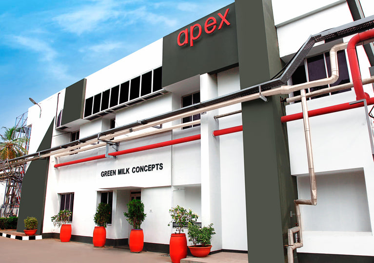 Building with 'apex' and 'Green Milk Concepts' branding on a clear day.