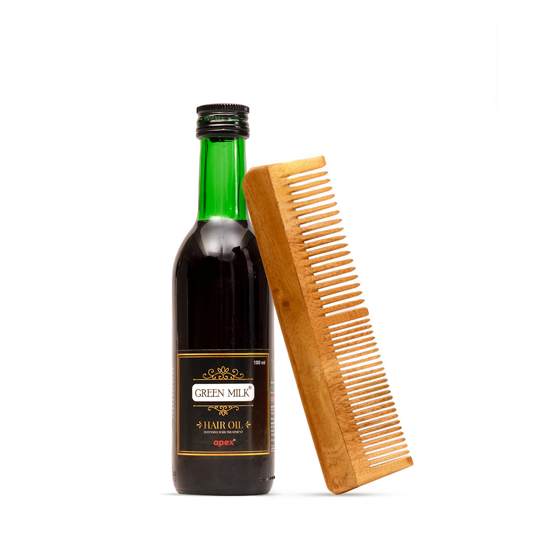 Bottle of Green Milk hair oil with a wooden comb on a white background