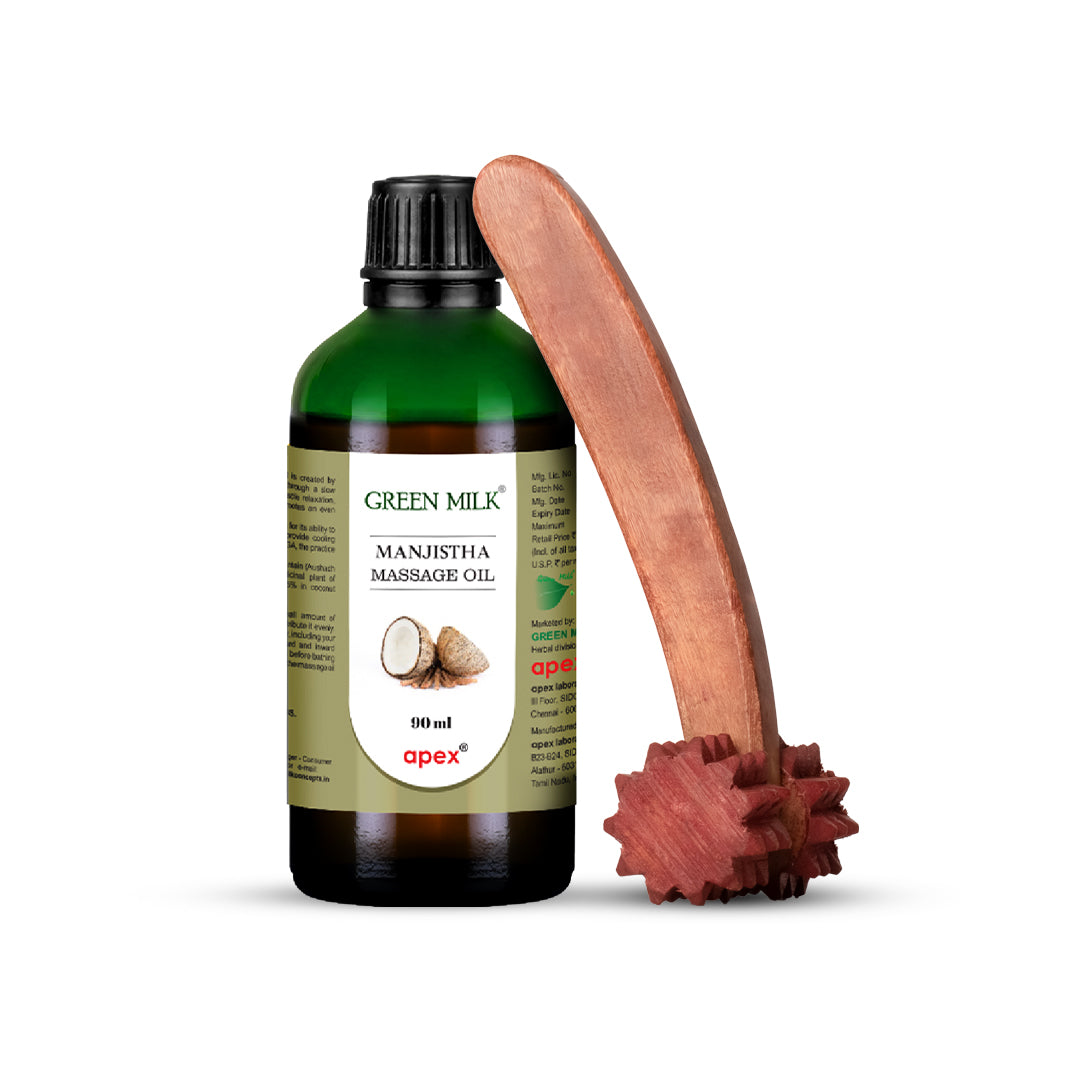 Bottle of Green Milk Manjistha Massage Oil with a wooden massage tool on a white background