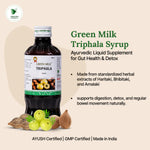 Green Milk Triphala Syrup bottle with product details on a beige background