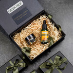 Green Milk product set in a gift box with decorative ribbons on a gray background